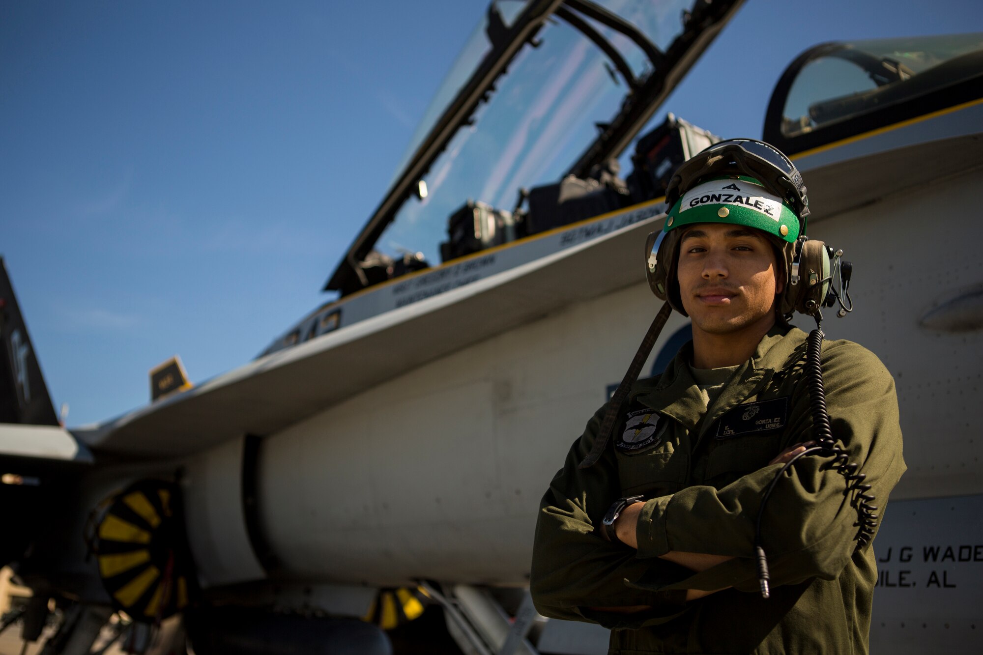 U.S. Marine Corps Lance Cpl. Emanuel Gonzalez, Marine All-Weather Fighter Attack Squadron (VMFA [AW]) 242, 1st Marine Aircraft Wing, air frames mechanic, poses for a photograph in front of a U.S. Marine Corps FA-18D Hornet during Exercise Northern Edge 15 at Eielson Air Force Base, Alaska, June 18, 2015. Northern Edge is Alaska’s premier joint training exercise designed to practice operations, techniques and procedures as well as enhance interoperability among the services. Thousands of Airmen, Soldiers, Sailors, Marines and Coast Guardsmen from active duty, Reserve and National Guard units are involved. (U.S. Marine Corps photo by Cpl. Suzanne Dickson/Released)
