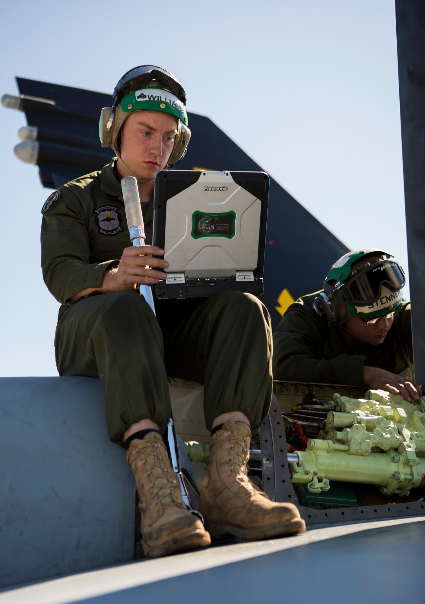 U.S. Marine Corps Cpl. Joshua D. Williams, Marine All-Weather Fighter Attack Squadron (VMFA [AW]) 242, 1st Marine Aircraft Wing, air frames mechanic, sits on top of a U.S. Marine Corps FA-18D Hornet while conducting routine maintenance during Exercise Northern Edge 15 at Eielson Air Force Base, Alaska, June 18, 2015. Northern Edge is Alaska’s premier joint training exercise designed to practice operations, techniques and procedures as well as enhance interoperability among the services. Thousands of Airmen, Soldiers, Sailors, Marines and Coast Guardsmen from active duty, Reserve and National Guard units are involved. (U.S. Marine Corps photo by Cpl. Suzanne Dickson/Released)