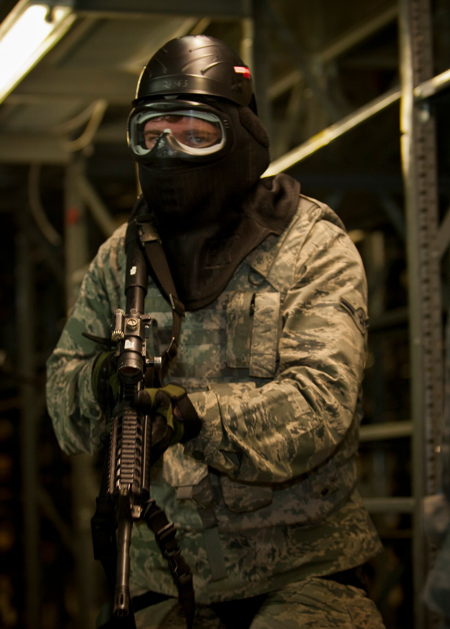 PETERSON AIR FORCE BASE, Colo. – Airman Dallas Hinman, 721st Security Forces Squadron member, advances through an industrial area of a warehouse to clear the area and find two rogue Airmen with weapons in a scenario during an annual training mission at the 21st Security Forces Training Complex, June 16. 721st SFS members conducted an active shooter, live-fire training using non-lethal training ammunition, which allows for the most realistic force-on-force training. (U.S. Air Force photo by Airman 1st Class Rose Gudex)