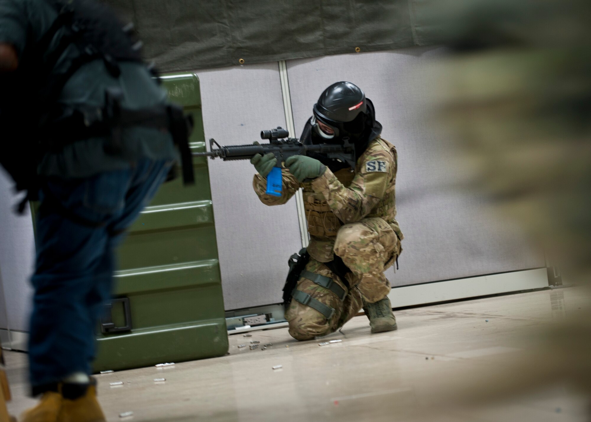 PETERSON AIR FORCE BASE, Colo. – A 721st  Security Forces Squadron member covers a teammate while clearing an area of “enemy forces” during an annual training mission at the 21st  Security Forces Training Complex, June 16. 721st  SFS members conducted an active shooter, live-fire training using non-lethal training ammunition, which allows for the most realistic force-on-force training. (U.S. Air Force photo by Airman 1st Class Rose Gudex)