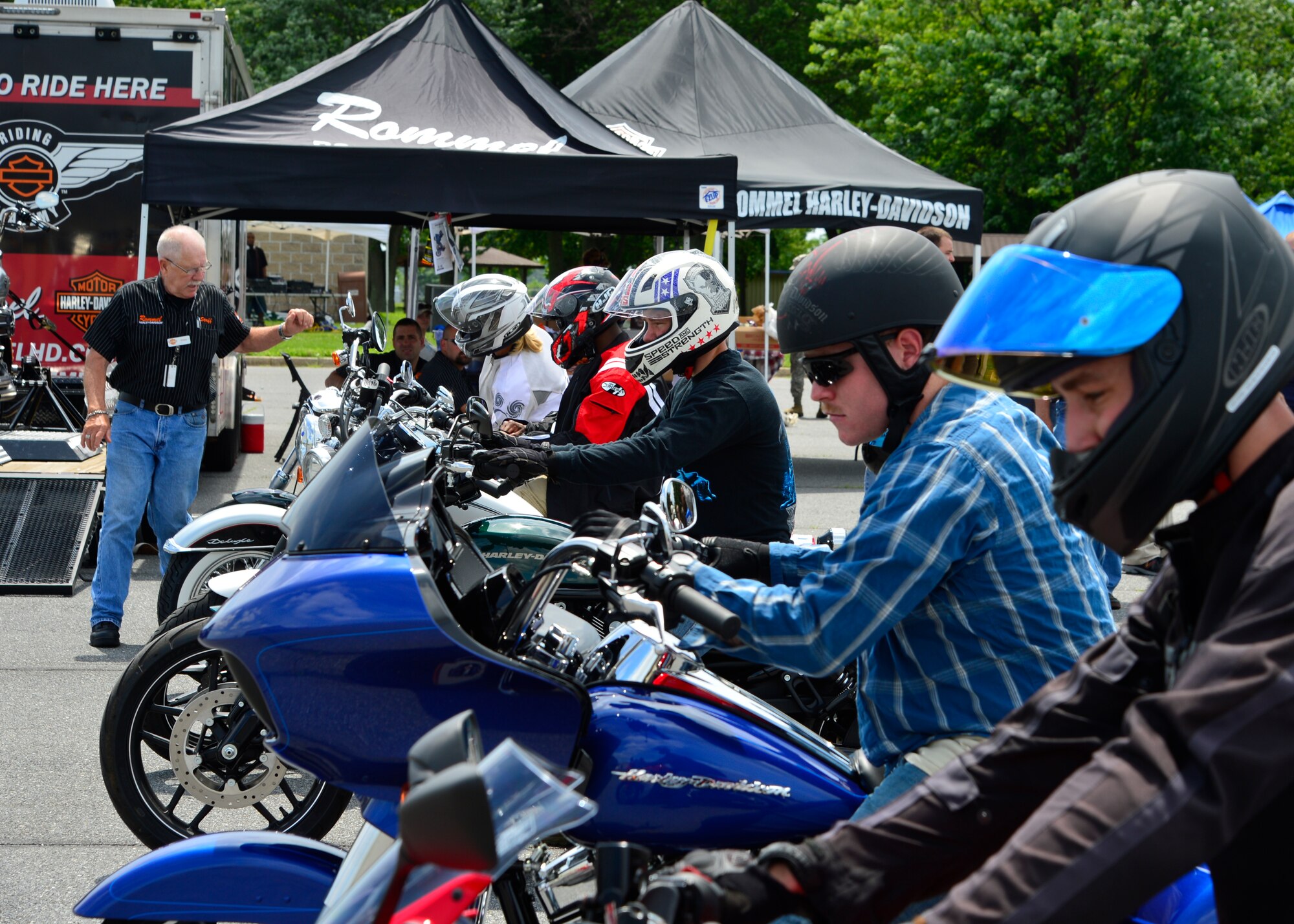 Team Dover Airmen line up to take demonstration motorcycles for test drives during Motorcycle Safety Day June 19, 2015, at Dover Air Force Base, Del. Airmen rode the 12-mile road course to improve their riding confidence on different types of motorcycles. (U.S. Air Force photo/Airman 1st Class William Johnson)