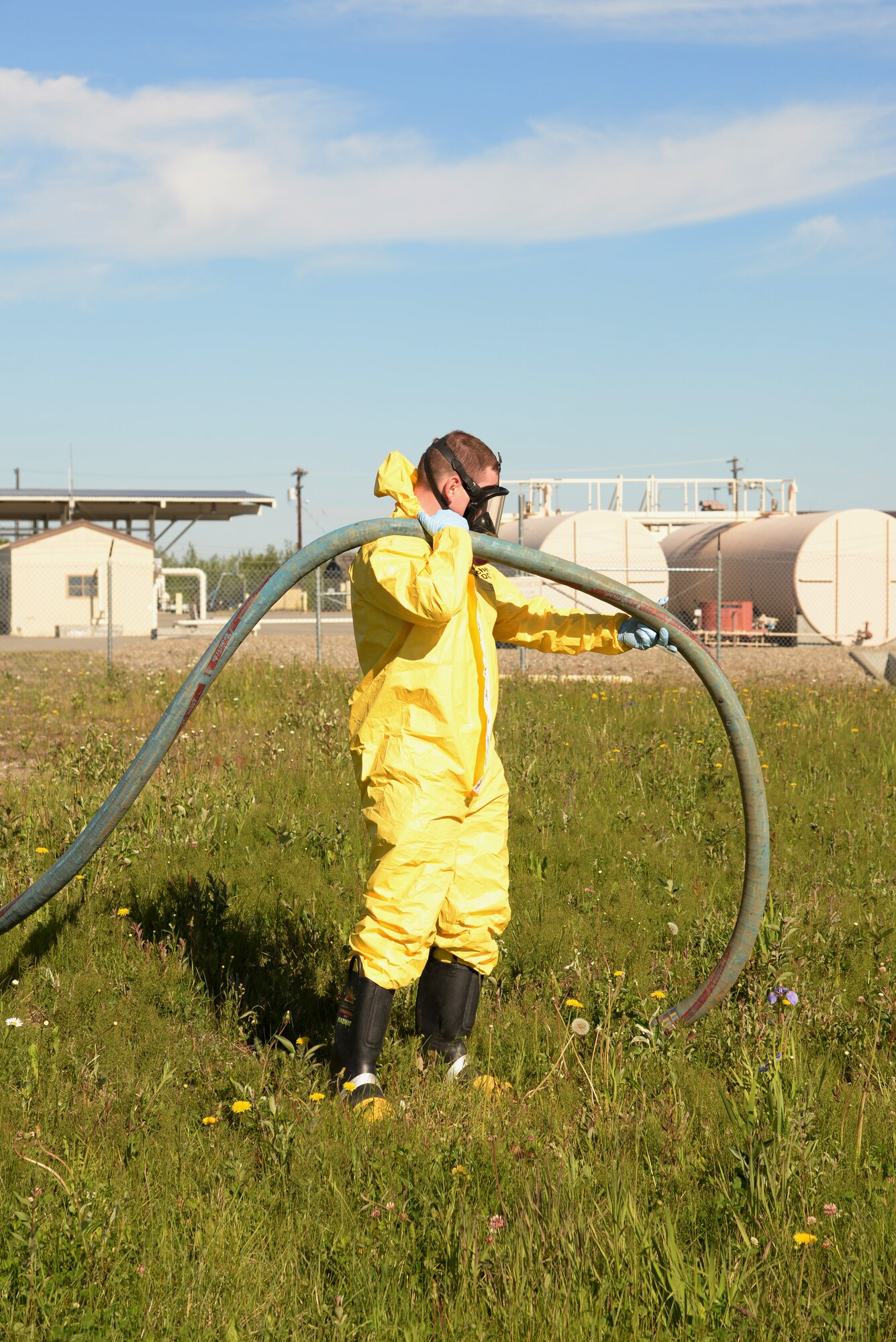 U.S. Air Force Airman 1st Class Zachary Dilling, a 354th Civil Engineer Squadron water and fuels system maintenance technician, simulates vacuuming up liquid waste that has pooled on the ground during a simulated 4.2-million gallon fuel spill exercise June 17, 2015, at Eielson Air Force Base, Alaska. The exercise is a Federal requirement conducted tri-annually to train and prepare fuels management and emergency services personnel in minimizing the environmental impact of a spill and in protecting and preserving public health and safety. (U.S. Air Force photo by Staff Sgt. Kirsten Wicker/Released)
