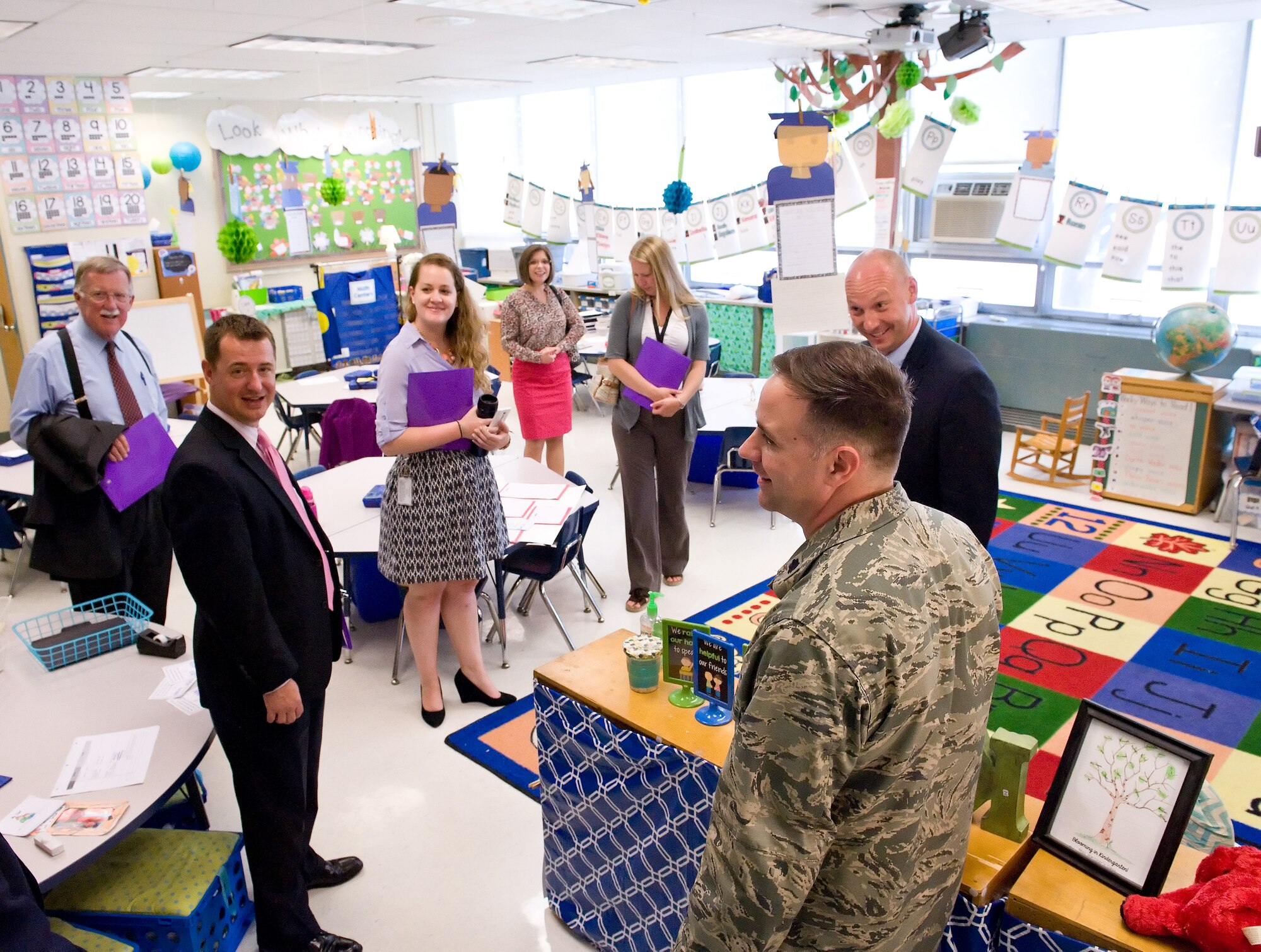 Lt. Col. Michael Phillips, 436th Mission Support Group deputy commander, near right, and Jason Payne, George S. Welch Elementary School principal, rear right, talk with Delaware state legislators and staff members in a kindergarten classroom June 9, 2015, at Welch Elementary School on Dover Air Force Base, Del. School-age children, kindergarten through the eighth grade living in the family housing area, are able to attend Welch Elementary and Dover AFB Middle School. (U.S. Air Force photo/Roland Balik)