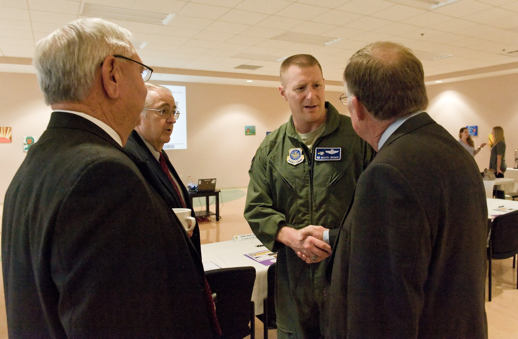 Col. Michael Grismer, 436th Airlift Wing commander, second from right, greets Sen. Brian Bushweller, Delaware 17th District, right, June 9, 2015, at the Youth Center on Dover Air Force Base, Del. Bushweller and other Delaware state legislators, as well as members of the Caesar Rodney School District, received a briefing by wing leadership on youth programs at the base and educational opportunities offered at the two schools located in the housing area. (U.S. Air Force photo/Roland Balik)
