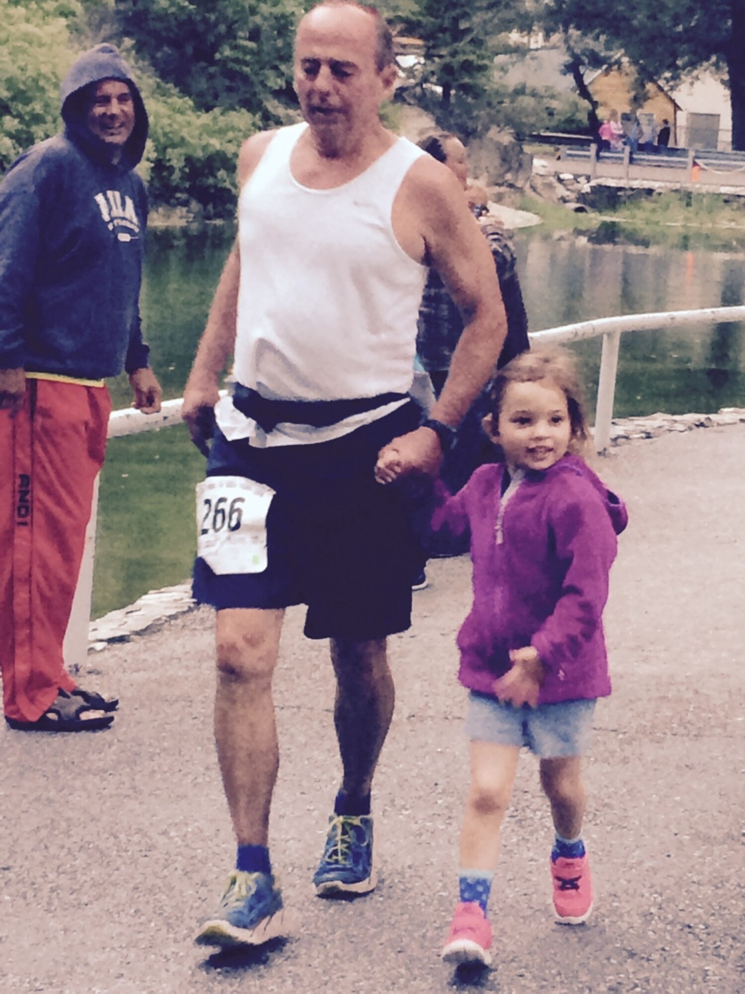 21st Space Wing Director of Staff Al Strait nears the finish of the Squaw Peak 50 Mile trail run above Provo, Utah June 6. His granddaughter accompanied him during the last 50 yards of the event. Strait finished his second attempt at the course in 16:22.