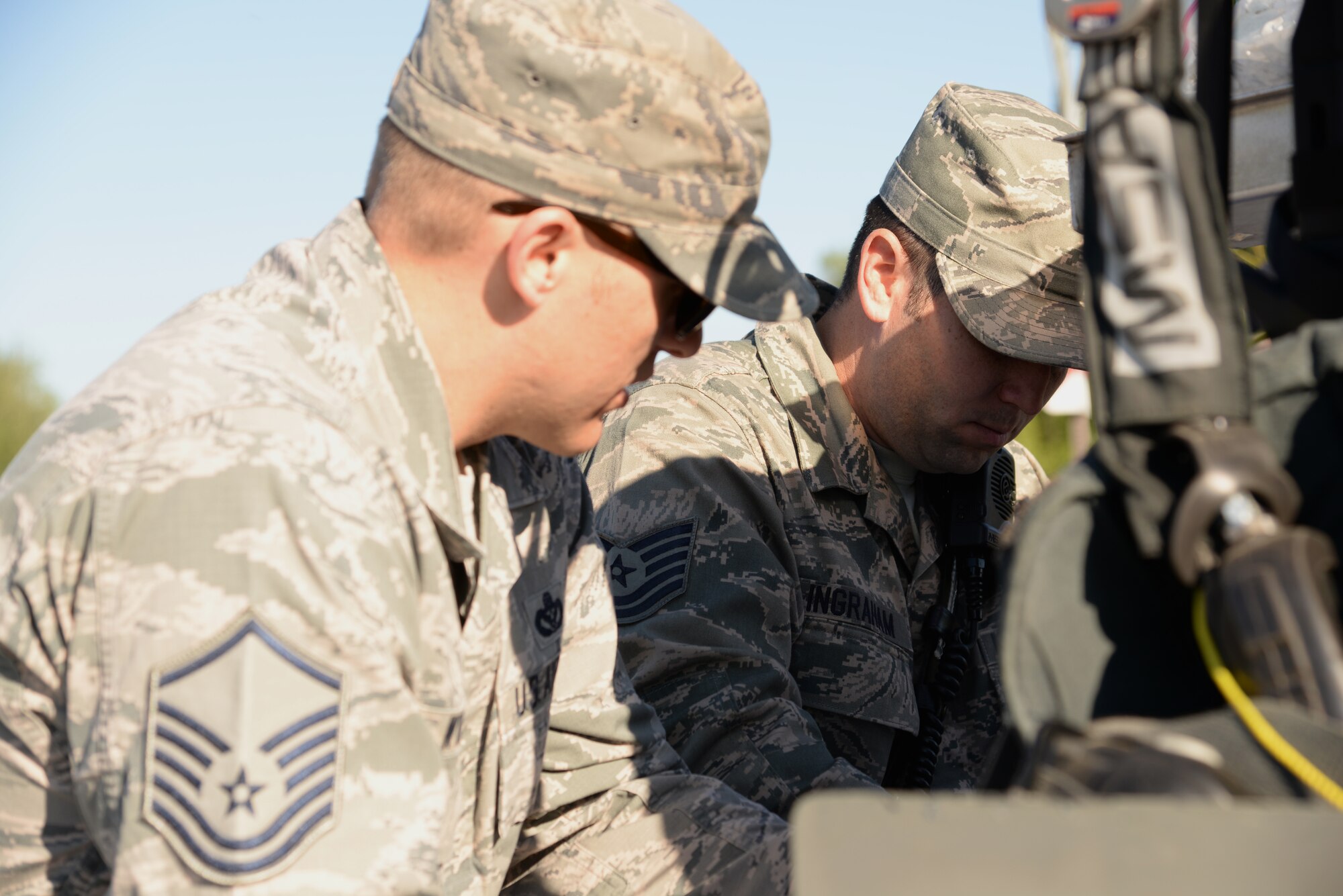 U.S. Air Force Master Sgt. Jeffrey Wyatt and Tech. Sgt. Timothy Ingraham, 354th Civil Engineer Squadron firefighters, begin running through a checklist in response to a simulated fuel spill during a fuels management exercise June 17, 2015, at Eielson Air Force Base, Alaska. The firefighters served as the incident commander and the operations commander during the large-scale 4.2-million gallon fuel spill exercise. The exercise is a Federal requirement conducted tri-annually to train and prepare fuels management and emergency services personnel in minimizing the environmental impact of a spill and in protecting and preserving public health and safety. (U.S. Air Force photo by Staff Sgt. Kirsten Wicker/Released)