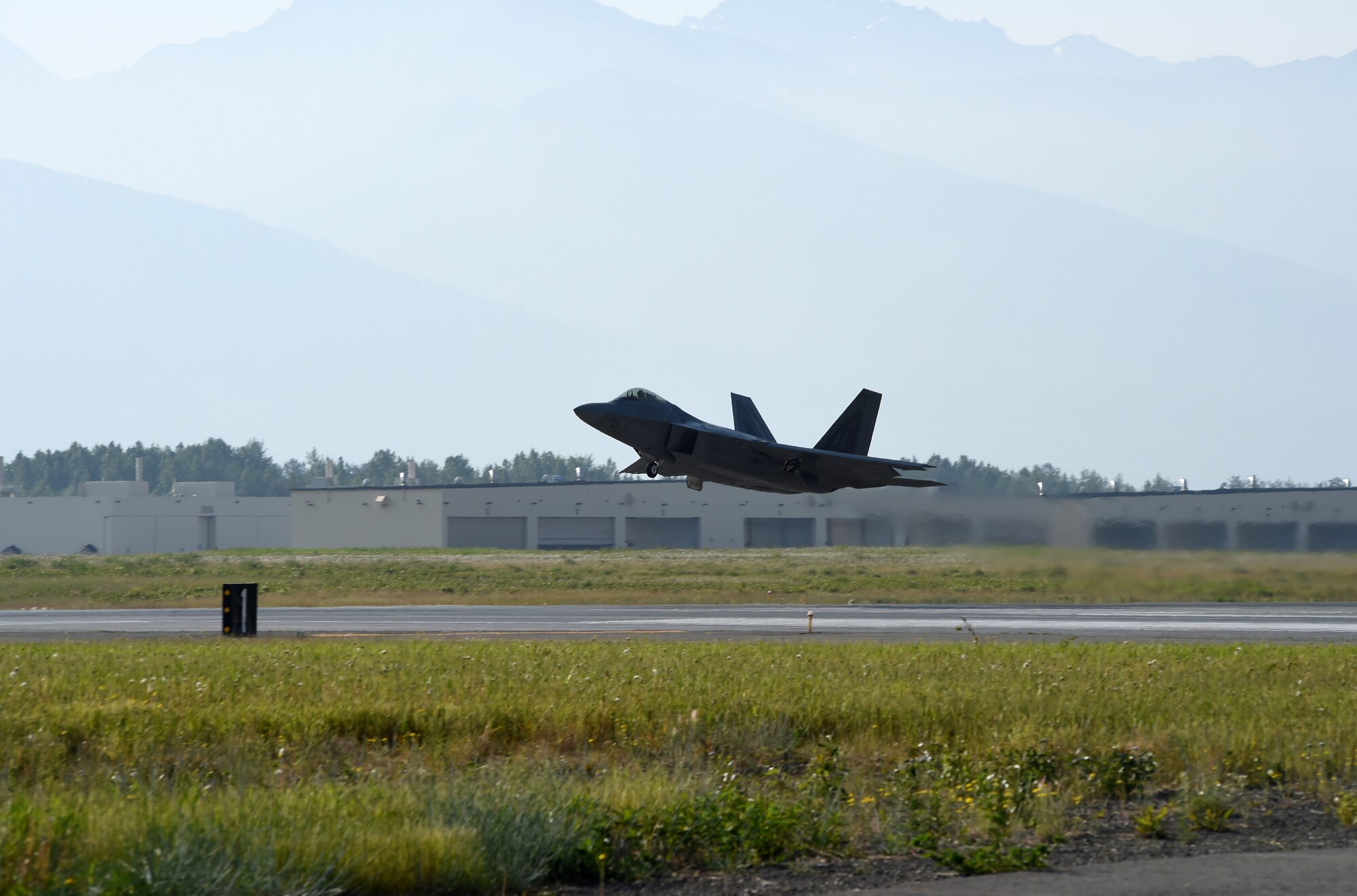 A F-22 Raptor from the 525 Fighter Squadron leaves for a mission during Exercise Northern Edge 15 at Joint Base Elmendorf-Richardson, June 18, 2015. Joint Base Elmendorf-Richardson, June 18, 2015. Northern Edge 15 is Alaska’s premier joint training exercise designed to practice operations, techniques and procedures as well as enhance interoperability among the services. Thousands of participants from all services; active duty, Reserve and National Guard units are involved. (U.S. Navy photo by Chief Mass Communication Specialist Larry Foos)
