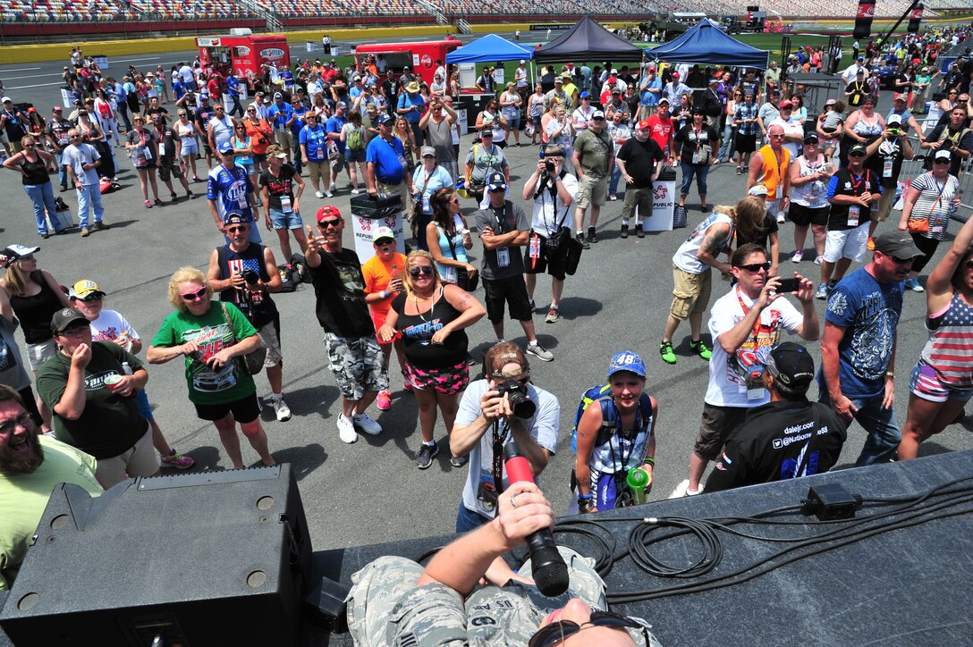 Fans gather as Senior Airman Melissa Lackore wraps up an energetic performance at NASCAR's COCA-COLA 600 over Memorial Day Weekend.  