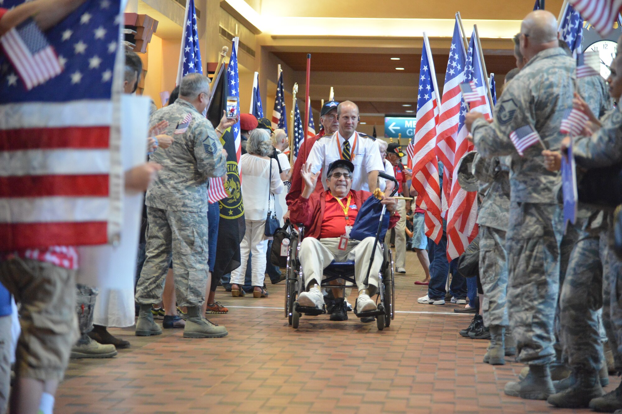 World War II veterans return to Albuquerque International Sunport Friday and are greeted by more than 200 people dressed in patriotic clothing and waving flags. (Photo by Todd Berenger)