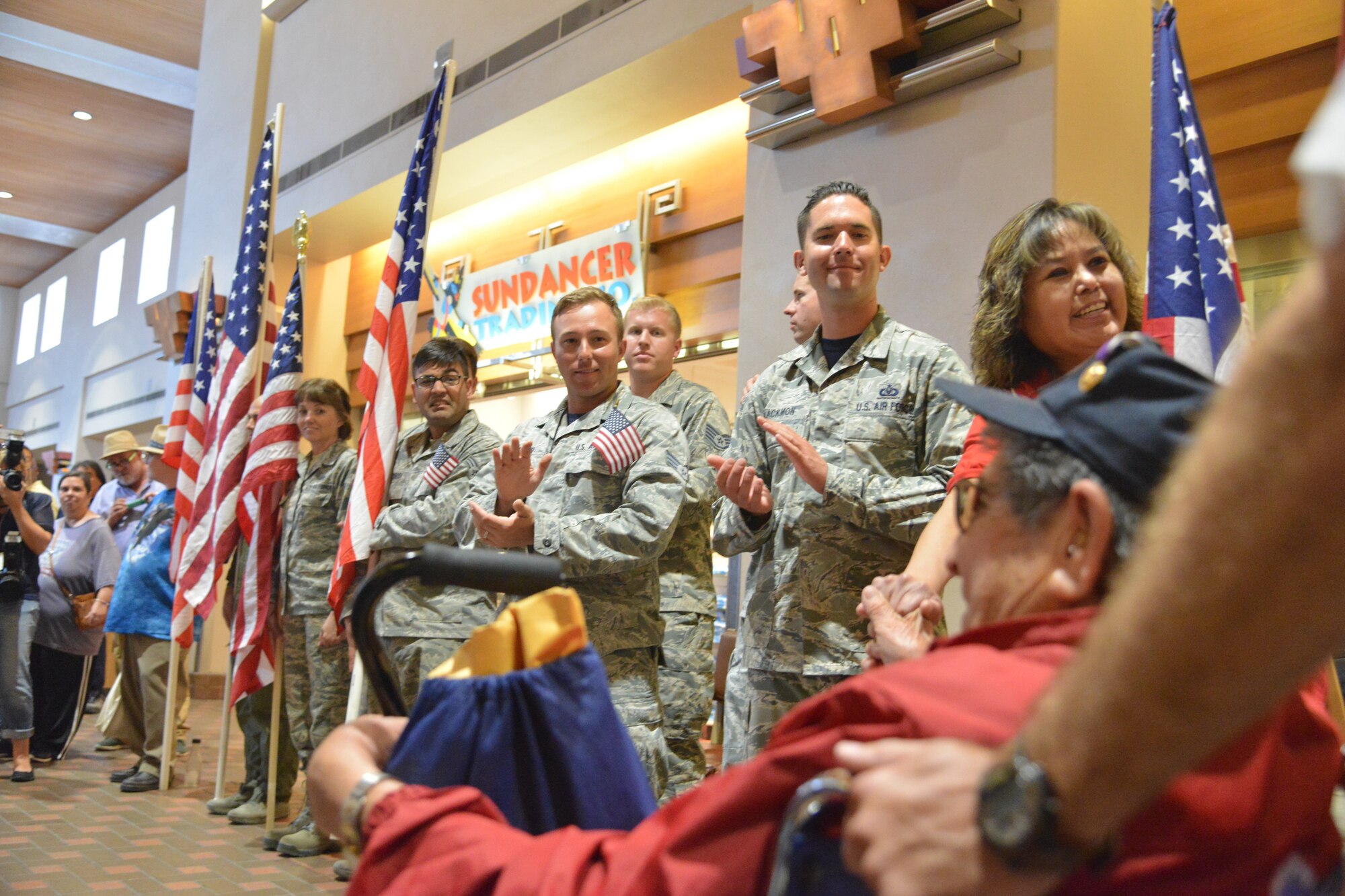 World War II veterans return to Albuquerque International Sunport Friday and are greeted by more than 200 people dressed in patriotic clothing and waving flags. (Photo by Todd Berenger)