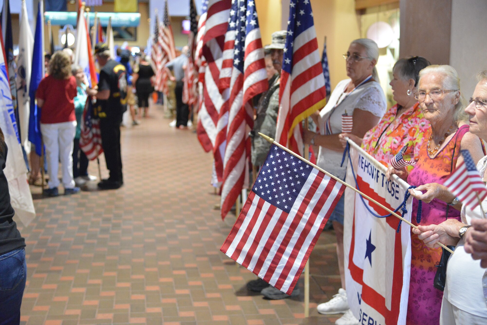World War II veterans return to Albuquerque International Sunport Friday and are greeted by more than 200 people dressed in patriotic clothing and waving flags. (Photo by Todd Berenger)