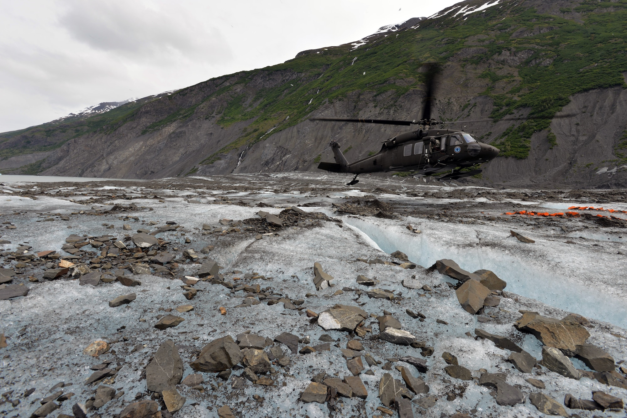 An Alaska National Guard UH-60 Black Hawk helicopter lands on Colony Glacier June 10 in order to transport servicemembers back to Joint Base Elmendorf-Richardson, Alaska. Each summer since 2012 Alaskan Command has supported Operation Colony Glacier by removing aircraft debris and assisting in the recovery of human remains to ensure closure for families who have lost loved ones. (U.S. Air Force photo/Tech. Sgt. John Gordinier)