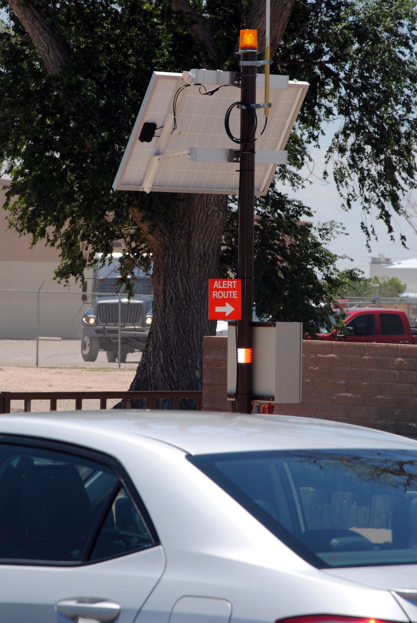 A car pulls over while an Alert Route Beacon Tower flashes on Texas Street recently. The beacons have been installed to ensure aircrews can travel to the flightline quickly and safely. The flashing yellow lights are a warning for motorists of potential emergency vehicles traveling on the route and motorists are advised to pull over and stop for any approaching emergency vehicle with lights and sirens. Drivers should pull over to the far right as safely as possible, and come to a complete stop, then wait for alert vehicles to pass and beacons to stop flashing before proceeding. (Photo by Jim Fisher). 