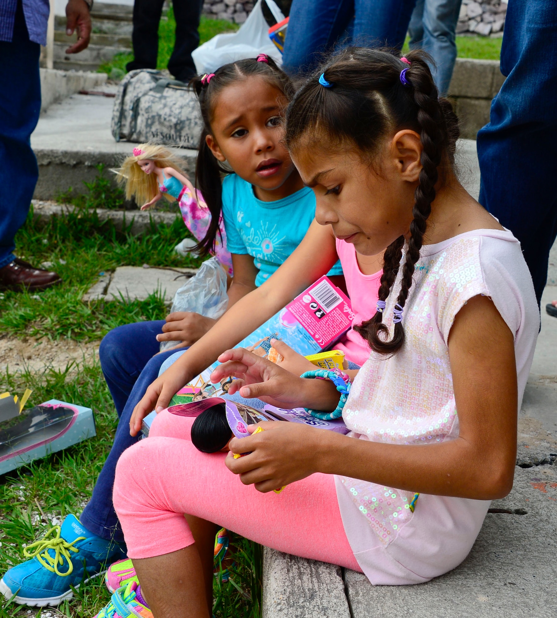 Young girls from the Casa de Corderitos orphanage in Tegucigalpa, Honduras play with their new Barbie dolls, June 18, 2015. The 12th AF (AFSOUTH) members spent some of their downtime during a three-day assessment visit to Honduras Air Bases to volunteer with the local community and to deliver toys and candy that were donated businesses in Tucson, Ariz. (U.S. Air Force photo by Tech. Sgt. Heather R. Redman/Released)