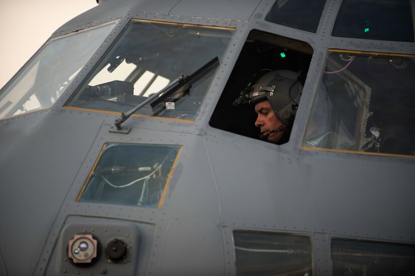 A pilot sits in the flight deck of a modified C-130 Hercules assigned to the 910th Airlift Wing, Youngstown Air Reserve Station, Ohio, June 19, 2015, at Joint Base Charleston, South Carolina. The C-130 Hercules and crew sprayed to eradicate mosquitos on the Joint Base Charleston Weapons Station and is the only unit of its kind. The crew performed aerial spraying at night to increase the chances of eliminating mosquitoes while reducing the risk of contaminating bees.  (U.S. Air Force photo/Senior Airman Jared Trimarchi) 