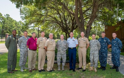 Col. Jeffrey DeVore (center), Joint Base Charleston commander, poses for a group photo with the Big 10 mission partners during a monthly Senior Leaders luncheon, June 18, 2015, at Joint Base Charleston, S.C. The luncheon provides leadership an opportunity to discuss any issues or concerns, give mission updates and build team cohesiveness. (U.S. Air Force photo/Senior Airman Jared Trimarchi) 