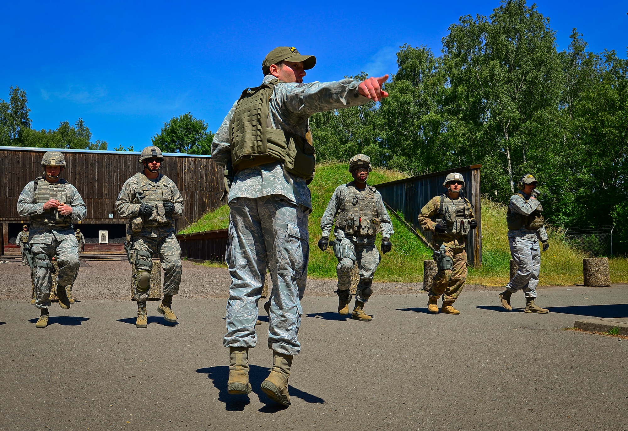 Staff Sgt. James Vetter, 435 Security Forces Squadron instructor, leads a squad through strenuous exercises until fatigued during live-fire, stress-fire training on Baumholder, Germany, June 18, 2015.  Live-fire, stress-fire training is one of 24 SF core tasks that must be completed during the base security operations course and gives students a realistic work environment for future operations while deployed. The students fire with no stress, then fire after completing the exercises.  (U.S. Air Force photo/Tech. Sgt. Daylena S. Ricks)