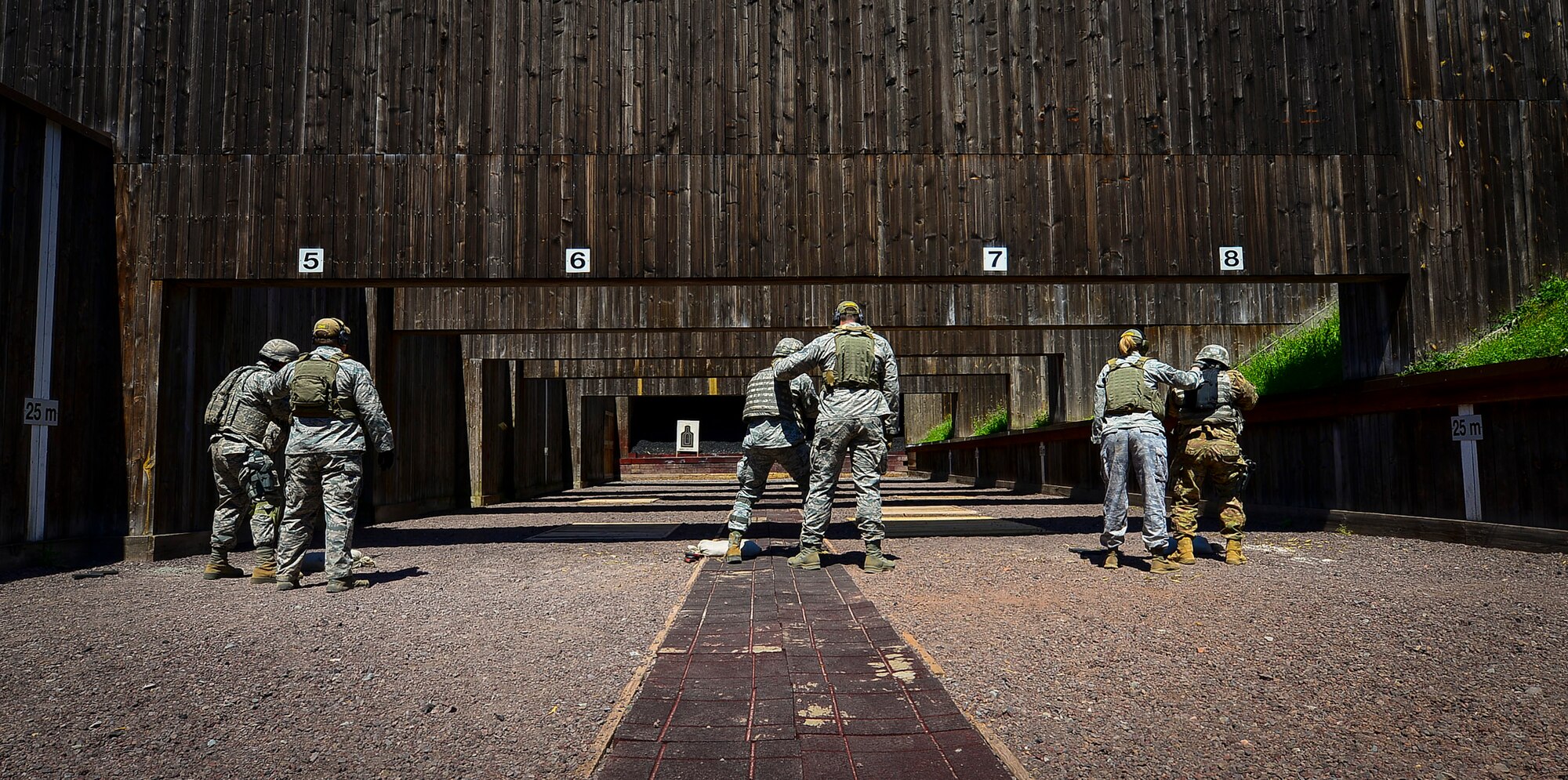 Creek Defender instructors ready the firing line during live-fire, stress-fire training on Baumholder, Germany, June 18, 2015.  Live-fire, stress-fire training is one of 24 SF core tasks that must be completed during the base security operations course and gives students a realistic work environment for future operations while deployed. The students fire with no stress, then fire after completing strenuous exercises until fatigued.  (U.S. Air Force photo/Tech. Sgt. Daylena S. Ricks)
