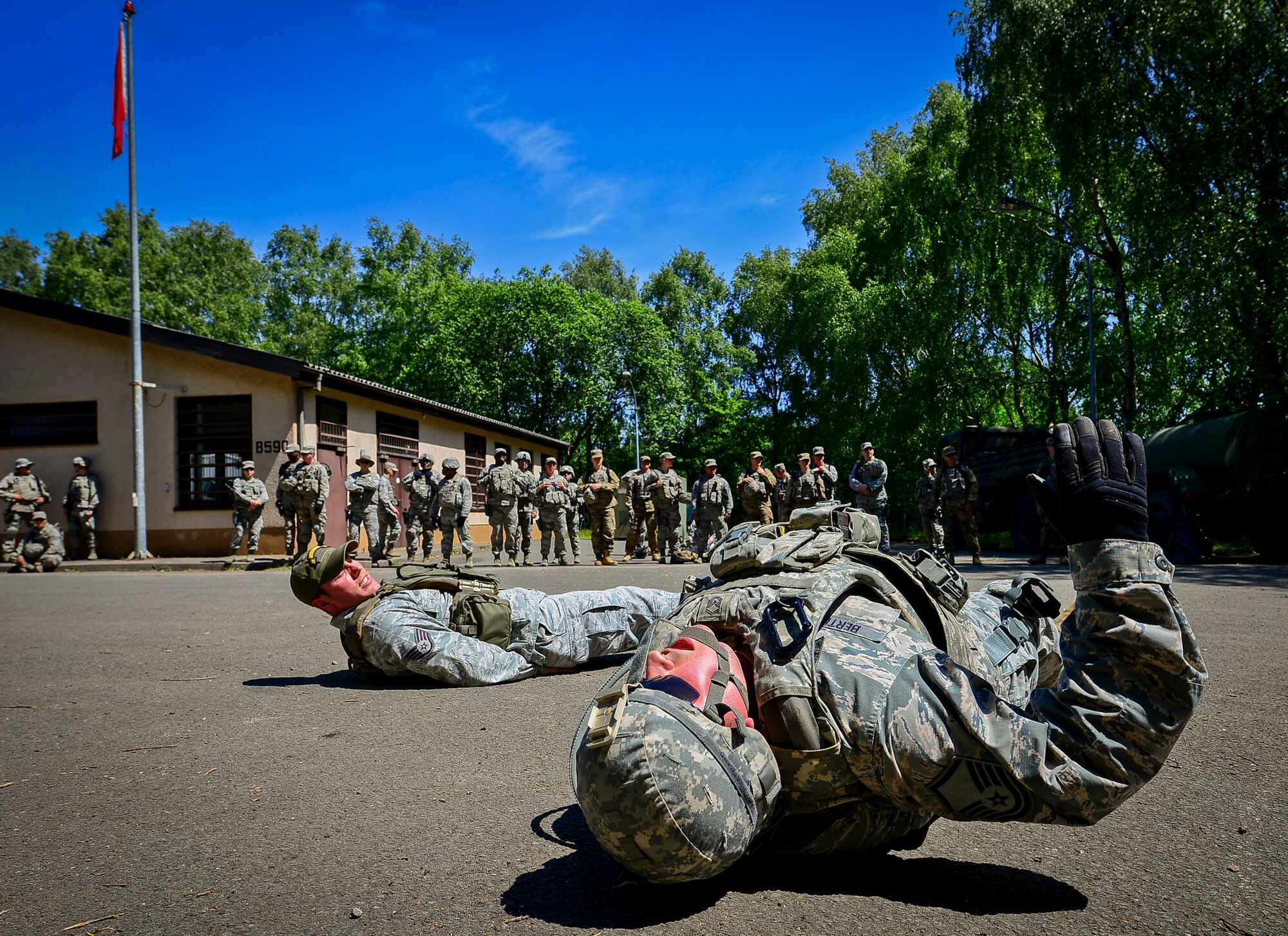 Master Sgt. Timothy Bertrand, 86th Security Forces Squadron NCO in charge of physical security, conducts flutter kicks during live-fire, stress-fire training on Baumholder, Germany, June 18, 2015.  Live-fire, stress-fire training is one of 24 SF core tasks that must be completed during the base security operations course and gives students a realistic work environment for future operations while deployed. The students fire with no stress, then fire after completing strenuous exercises until fatigued.  (U.S. Air Force photo/Tech. Sgt. Daylena S. Ricks)