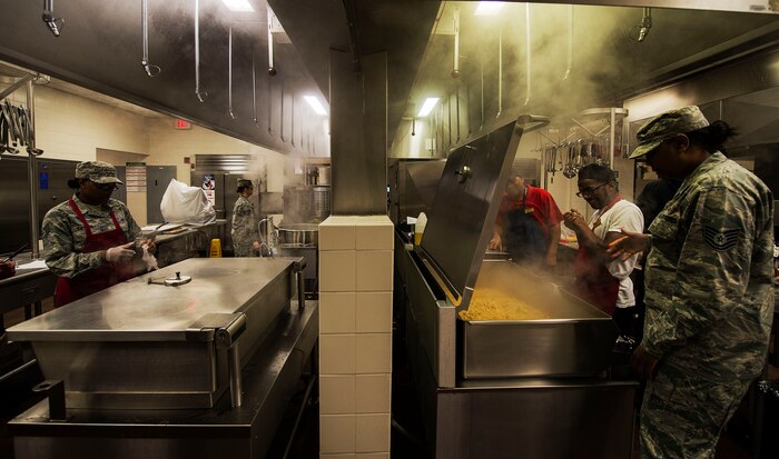 Airmen from the 628th Force Support Squadron Gaylor Dining Facility work to prepare lunch at Joint Base Charleston, S.C. April 08, 2015. 628th FSS Airmen are tasked with providing meals to thousands of fellow Airmen daily. (U.S. Air Force photo by Staff Sgt. Kenneth W. Norman)