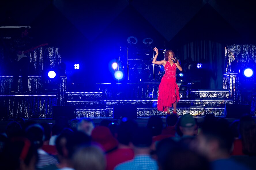 U.S. Air Force 2d Lt. Nicque Robinson, Tops in Blue vocalist, dances across the stage during a performance June 12, 2015, at Wild Adventures in Valdosta, Ga. Robinson is a contracting specialist at the 319th Contracting Flight. (U.S. Air Force photo by Senior Airman Ryan Callaghan/Released)