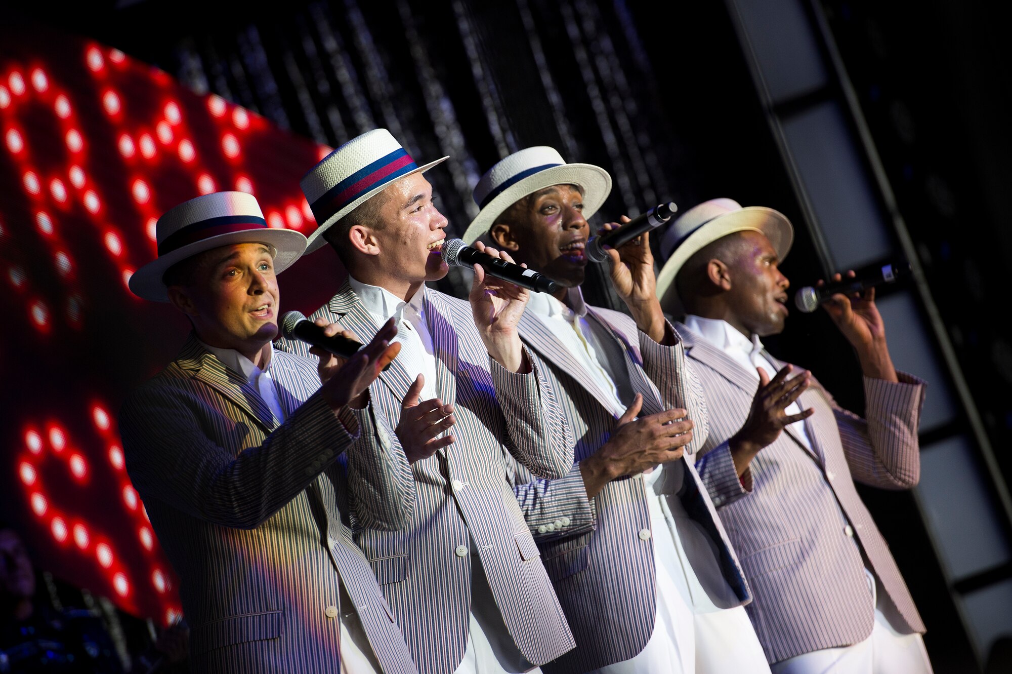 Tops in Blue performers sing in an a capella group during a performance June 12, 2015, at Wild Adventures in Valdosta, Ga. Tops in Blue tour worldwide in an effort to raise morale for service members and their families, promote community relations and support recruiting efforts. (U.S. Air Force photo by Senior Airman Ryan Callaghan/Released)
