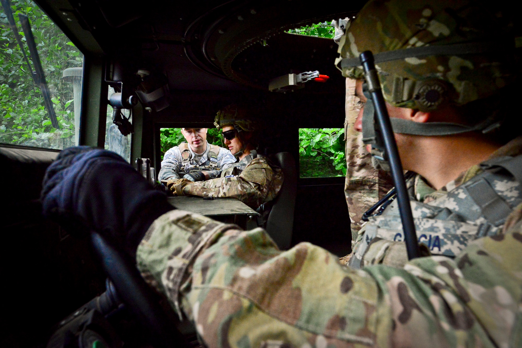 Staff Sgt. Laura Barrett, 86th Security Force Squadron evaluator, gives Staff Sgt. Timothy Kennedy, 435th SFS senior instructor a nine line report during a field exercise on Baumholder, Germany, June 15, 2015.  Sand tables are used to conduct rehearsal prior to  missions.  (U.S. Air Force Photo/Tech. Sgt. Daylena S. Ricks)