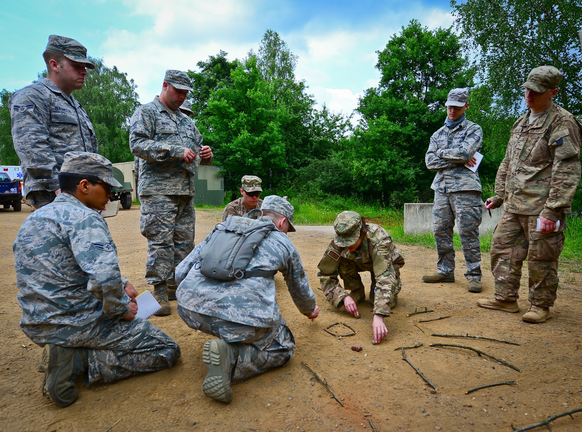 Staff Sgt. Laura Barrett, 86th Security Force Squadron evaluator, uses the sand table to rehearse an upcoming mission on Baumholder, Germany, June 15, 2015.  Sand tables are used to conduct rehearsal prior to  missions.  (U.S. Air Force Photo/Tech. Sgt. Daylena S. Ricks)

