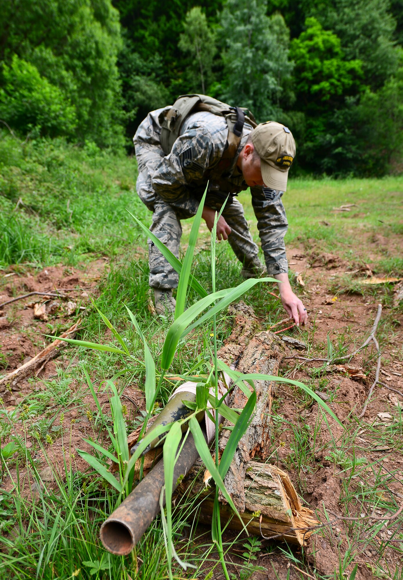 Staff Sgt. Timothy Kennedy, 435th Security Forces Squadron senior instructor, prepares a training improvised explosive device on Baumholder, Germany, June 15, 2015.  Training IEDs provide realistic scenarios for students completing the base security operations course prior to deployment.  (U.S. Air Force Photo/Tech. Sgt. Daylena S. Ricks)
