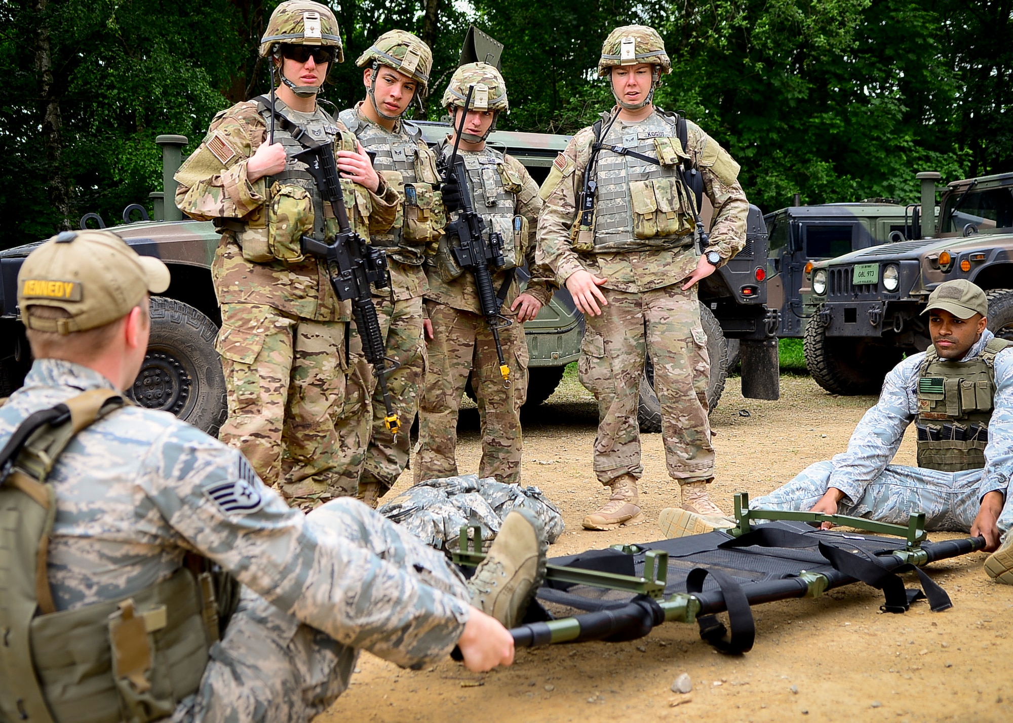 Staff Sgts. Timothy Kennedy and Spencer Wallace, 435th Security Forces Squadron senior instructors, demonstrate the correct way to conduct pre-combat inspections to the aid and litter team on Baumholder, Germany, June 15, 2015.  All equipment must be deemed operational prior to combat.  (U.S. Air Force Photo/Tech. Sgt. Daylena S. Ricks)