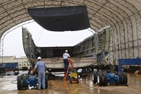 Members of the 502nd Trainer Development Squadron and aircraft transportation contractors work together to prepare a C-17 Globemaster III fuselage June 21 for its journey to its final destination at the U.S. Air Force School of Aerospace Medicine at Wright-Patterson Air Force Base, Ohio. There it will be reassembled into the first aeromedical evacuation training center for students at USAFSAM.  The transformation required a rebuild of the interior to replicate an actual C-17 that has the capability to transport patients. The fuselage was also engineered to provide several simulated capabilities to include sounds, temperature changes, smoke and other variances to provide a realistic C-17 aeromedical training environment. (U.S. Air Force photo by Senior Airman Alexandria Slade)