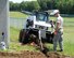 Master Sgt. Jason Bowen, team chief (right) motions to Senior Airman David Kearns as he uses a Bobcat to dig a trench for a grounding ring as part of lightning protection and grounding upgrades on communications equipment at Pease Air National Guard Base, N.H., on June 22, 2015.  The installation of the lightning protection gear helps protect resources such as radios that 157th Air Refueling Wing Airmen use to support the mission.The Airmen are assigned to the 243rd Engineering Installation Squadron, Maine Air National Guard in South Portland, Maine.  (U.S. Air National Guard photo by Staff Sgt. Curtis J. Lenz)