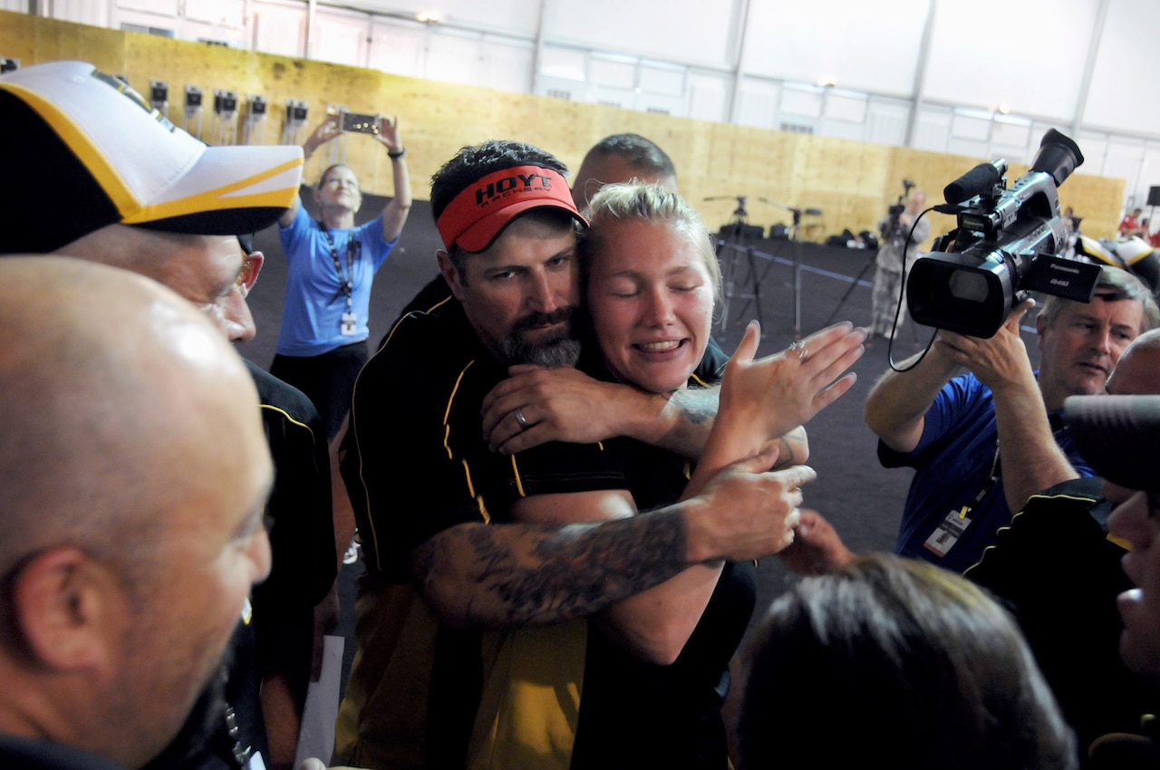 Army veteran Staff Sgt. Billy Meeks congratulates his teammate, Army Spc. Chasity Kuczer, on her win during the archery competition at the 2015 DoD Warrior Games on Marine Corps Base Quantico, Va., June 22, 2015. Meeks earned a silver medal in the recurve competition and Kuczer earned the gold medal in the compound. Meeks also earned a gold medal on the Army Team for recurve and Kuczer earned a gold medal on the Army Team for compound. DoD photo by Shannon Collins
