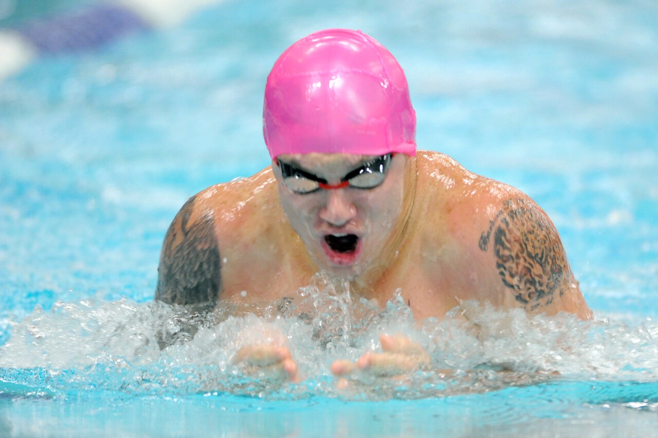 Kyle Reid, then a corporal in the Marine Corps, swims to gold in the 50-meter breaststroke finals during the 2014 Warrior Games in Colorado Springs, Colo., Sept. 30, 2014. Reid is competing in multiple events June 19-28 at the 2015 Warrior Games on Marine Corps Base Quantico, Va. DoD News photo by EJ Hersom