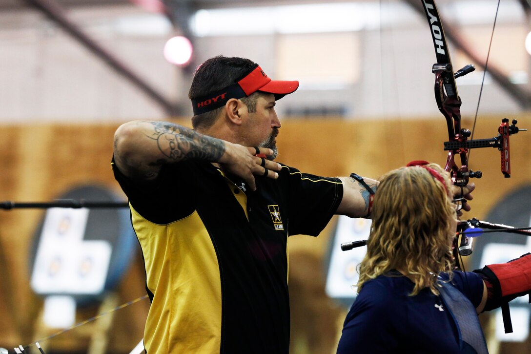 Army veteran Billy Meeks releases his arrow as he competes in the archery competition at the 2015 Department of Defense Warrior Games on Marine Corps Base Quantico, Va., June 22, 2015.