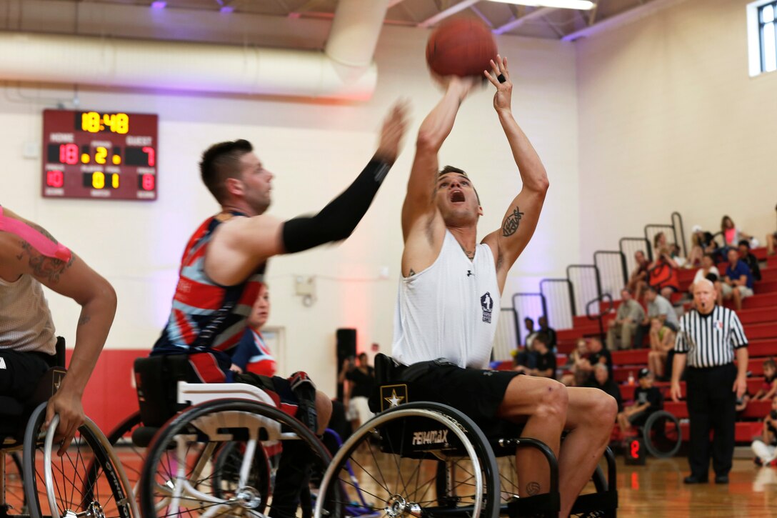 U.S. Army Sgt. Nicholas Titman, right, takes a shot while playing a wheelchair basketball game against Team British Armed Forces during the 2015 Department of Defense Warrior Games at Barber Fitness Center on Marine Corps Base Quantico, Va., June 21, 2015. 