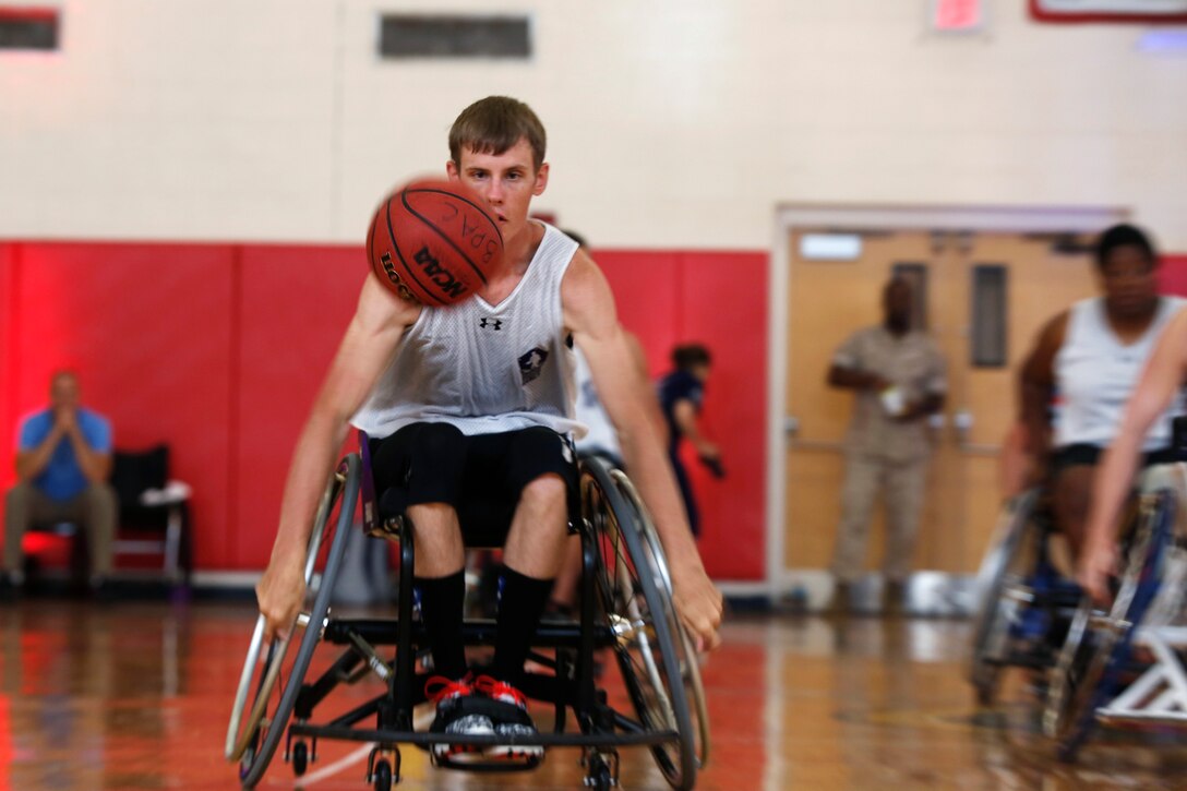 U.S. Army Spc. Terry Cartwright dribbles toward the basket for a shot during a wheelchair basketball game at the 2015 Department of Defense Warrior Games on Marine Corps Base Quantico, Va., June 21, 2015. 