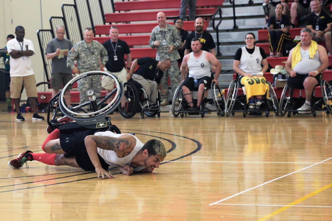 U.S. Army veteran Spc. Dustin Barr falls from his wheelchair during a wheelchair basketball game against the British Armed Forces team at the 2015 Department of Defense Warrior Games on Marine Corps Base Quantico, Va., June 21, 2015. 
