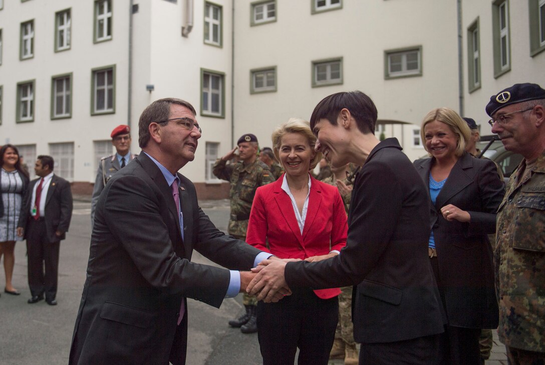 Dutch Defense Minister Jeanine Hennis-Plasschaer greets U.S. Defense Secretary Ash Carter as he arrives at 1 German Netherlands Corps, a multinational high readiness corps headquarters based in Munster, Germany, June 22, 2015.