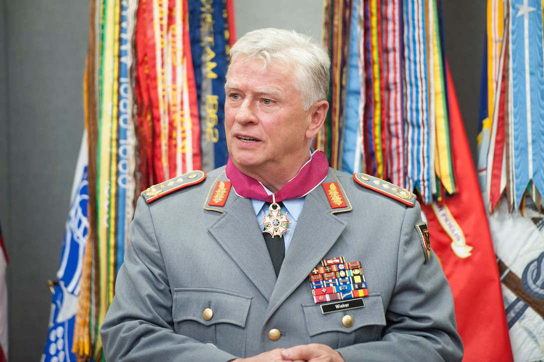 German Army Gen. Volker Wieker, chief of staff for Germany's armed forces, speaks after receiving an award from U.S. Army Gen. Martin E. Dempsey, chairman of the Joint Chiefs of Staff, at the Pentagon, June 23, 2015. 