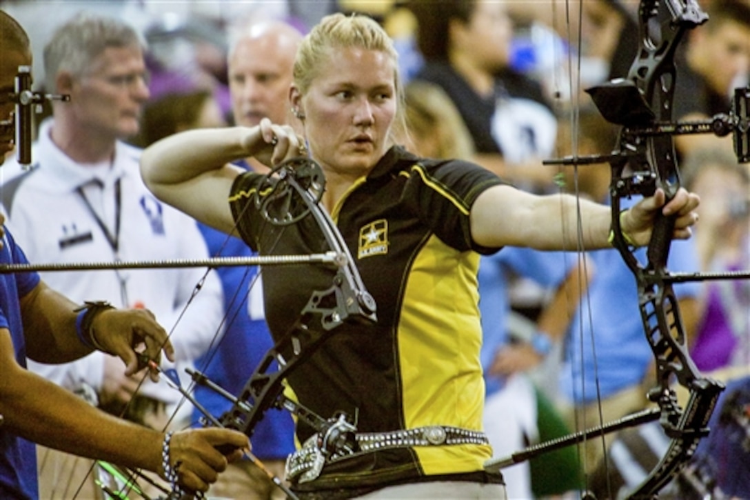 Army Spc. Chasity Kuczer follows through on her shot during the individual round of the archery competition during the 2015 Department of Defense Warrior Games on Marine Corps Base Quantico, Va., June 22, 2015.