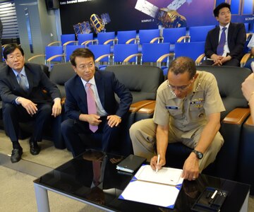 U.S. Navy Adm. Cecil D. Haney (front right), U.S. Strategic Command commander, signs a guest book during a meeting with Dr. In Sun Kim (second from left), Korea Aerospace Research Institute vice president, and members of his staff, June 23, 2015, during Haney's recent visit to the Republic of Korea. Haney traveled to the Asia-Pacific region to continue building and maintaining enduring relationships with partner nations and other combatant commands. During his visit to the Republic of Korea, he met with senior leaders for a variety of bilateral discussions on topics of mutual interest. The trip supports USSTRATCOM's efforts to confront the broad range of global strategic challenges and the United States' rebalance to the Pacific. USSTRATCOM is one of nine DoD unified combatant commands and is charged with strategic deterrence; space operations; cyberspace operations; joint electronic warfare; global strike; missile defense; intelligence, surveillance and reconnaissance; combating weapons of mass destruction; and analysis and targeting. (USSTRATCOM photo by U.S. Navy Capt. Pamela S. Kunze)