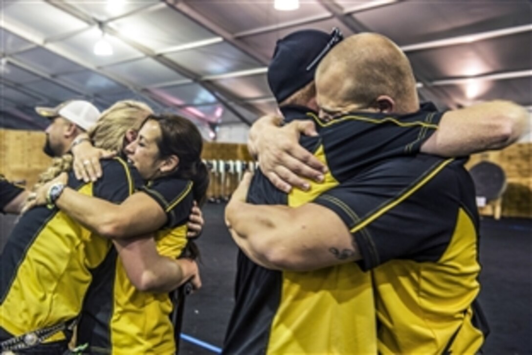 Team Army members celebrate after winning the gold medal for both the team compound and recurve events during the archery competition at the 2015 Department of Defense Warrior Games on Marine Corps Base Quantico, Va., June 22, 2015. 