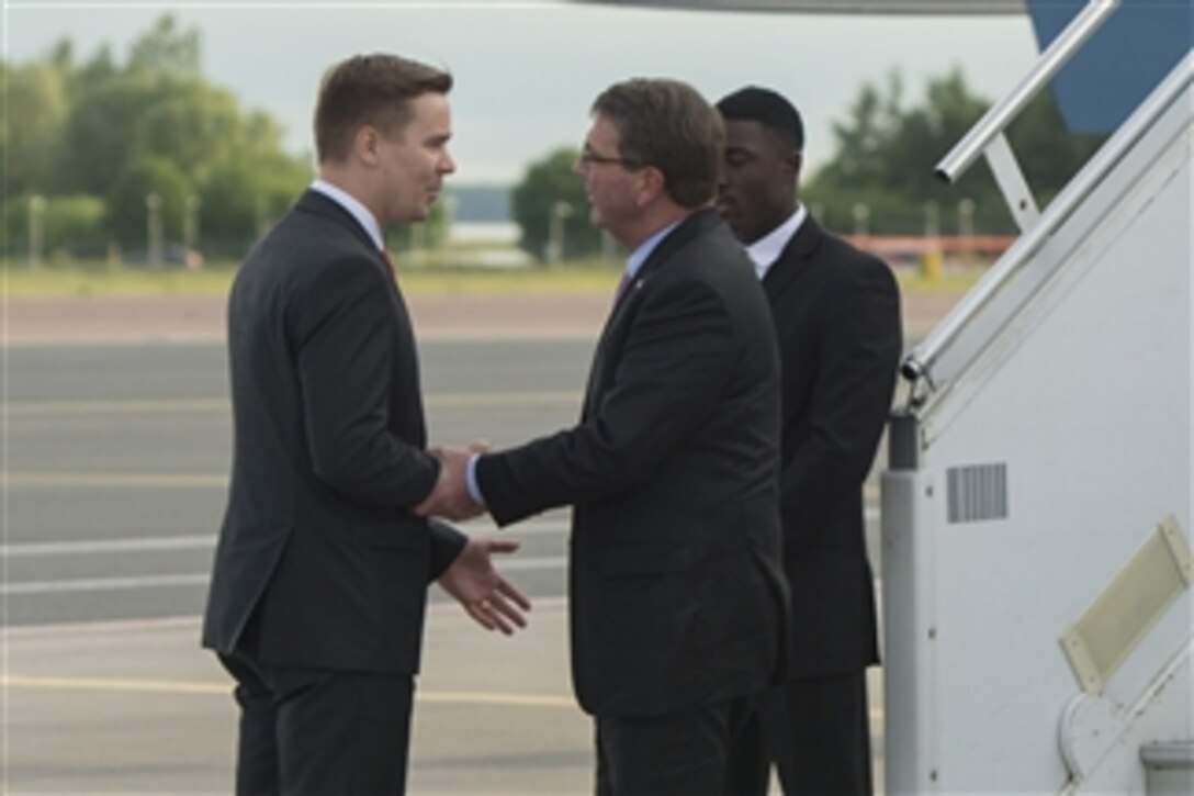 U.S. Defense Secretary Ash Carter, front right, exchanges greetings with Mikk Marran, the permanent secretary of defense of the Estonian Ministry of Defense, upon arriving in Tallinn, Estonia, June 22, 2015. Carter is in Europe to hold bilateral and multilateral meetings with European defense ministers and to participate in his first NATO ministerial as defense secretary.