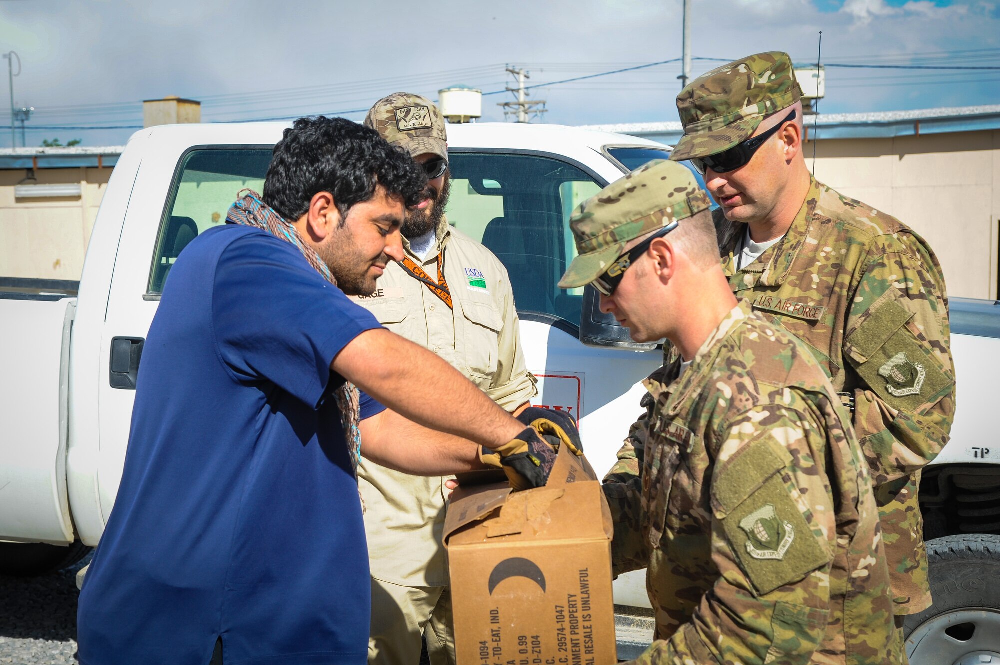 The 455th Air Expeditionary Wing Safety Office team shows a local Afghan a falcon captured on base April 30, 2015, at Bagram Airfield, Afghanistan. The team assisted the wildlife biologist in rescuing the bird. (U.S. Air Force photo by Maj. Tony Wickman/Released)
