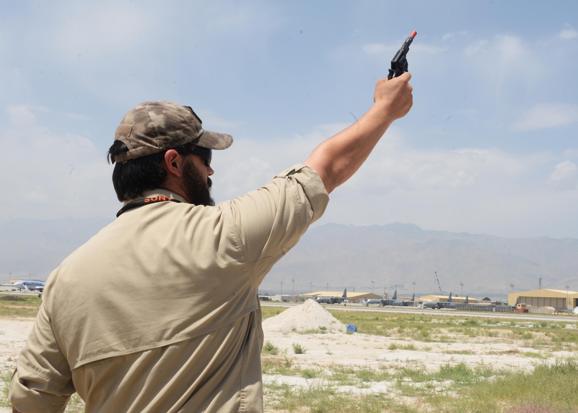 Matthew Gage, 455th Expeditionary Safety Office wildlife biologist, fires off a pistol to scare away birds that are a potential risk to aircraft at Bagram, June 22, 2015, at Bagram Airfield, Afghanistan. Gage is responsible for safely removing animals and birds that cause a risk to flight line and aircraft operations. Since 2009, a dozen biologists from USDA's Wildlife Services program have served four-month deployments at Bagram and elsewhere in the theater of
operations (U.S. Air Force photo by Senior Airman Cierra Presentado/Released)

