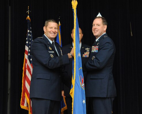 Gen. Robin Rand, commander of Air Education and Training Command, presents the unit guidon to Maj. Gen. James B. Hecker during the 19th Air Force assumption of command ceremony, June 23, 2015 at Joint Base San Antonio-Randolph, Texas. The 19th Air Force is responsible for the training of aircrews, remotely piloted aircraft crews, air battle managers, weapons directors, Air Force Academy Airmanship programs, and survival, escape, resistance, and evasion specialists to sustain the combat capability of the United States Air Force, other services and our nation's allies. (U.S. Air Force photo by Melissa Peterson)
