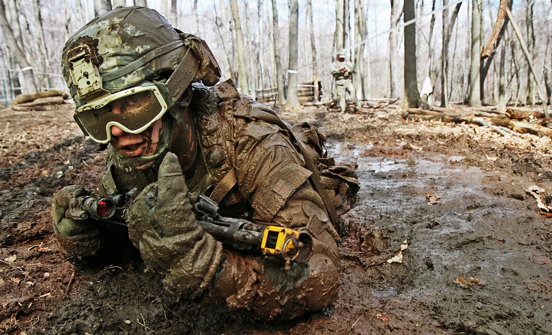 Crawling through mud, Army Pvt. Charles Shidler, Alpha Company, Special Troops 
Battalion, 37th Infantry Brigade Combat Team, Ohio National Guard, searches 
for the next covered fighting position during individual movement techniques 
training at the Camp Ravenna Joint Maneuver Training Center, Ravenna, Ohio, 
April 17, 2010. The IMT is just one of more than 200 common training tasks 
that Shidler, as well as about 3,600 other Soldiers of the 37th brigade, must 
complete before they are scheduled to deploy to Afghanistan in fall 2011 in 
support of Operation Enduring Freedom.