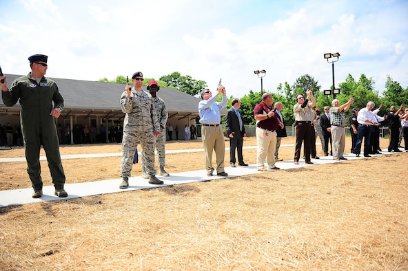 Col. John Nichols, 14th Flying Training Wing Commander, and Maj. Brenton Pickrell, 14th Security Forces Squadron Commander, lead a line of 14 shooters to officially open the Columbus Lowndes County Small Arms Range May 8 in Lowndes County, Mississippi. Distinguished shooters included Mississippi Governor Phil Bryant and other local community members who contributed to the planning and construction of the $1.9 million facility. (U.S. Air Force photo by Airman Daniel Lile)