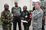 Lt. Col. Mark Desjardins (right) speaks with military members representing the Democratic Republic of the Congo and the Rwandan attendees of MEDLITE 11, April 26, 2011, at Kinshasa, Democratic Republic of the Congo. MEDLITE 11 is a joint medical exercise focused on aeromedical evacuation, to improve the readiness of U.S. Air Force and DRC personnel. Colonel Desjardins is a family practice doctor with the Rhode Island Air National Guard's 143rd Airlift Wing. (U.S. Air Force photo/Tech. Sgt. John Orrell)
